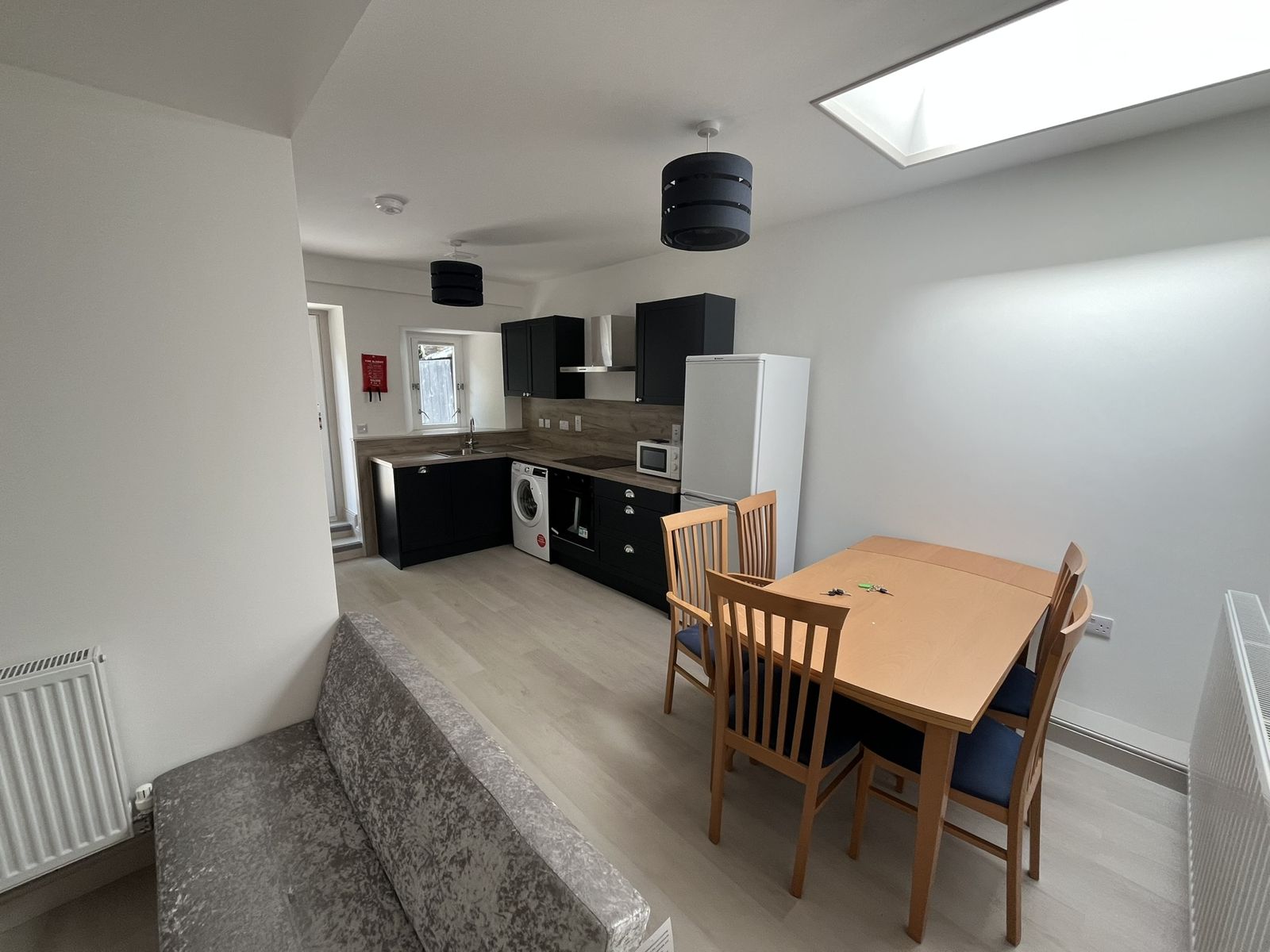 Open plan kitchen and dining room with roof light