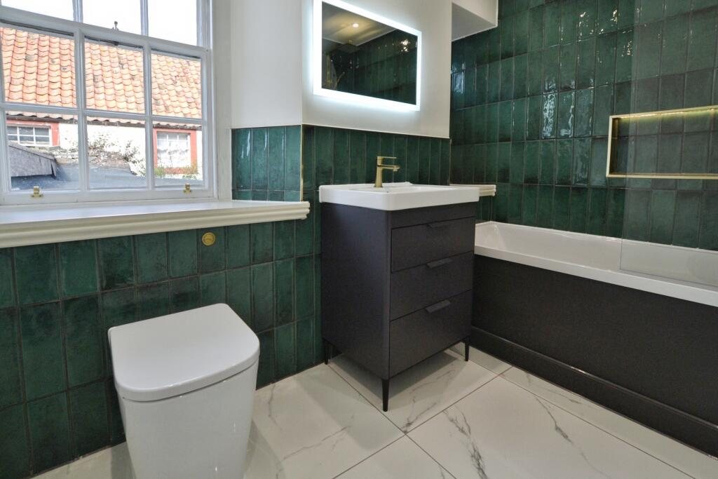 Bathroom with green glazed tiles